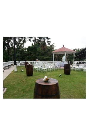 a wedding ceremony set up with beer barrels and chairs