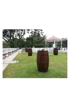 a group of beer barrels in a grassy area