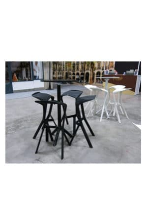 a set of replica miura stools and a table in a warehouse