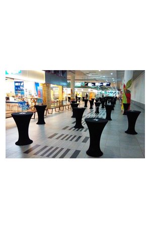 bombo table with black spandex and chairs in a mall with black tablecloths