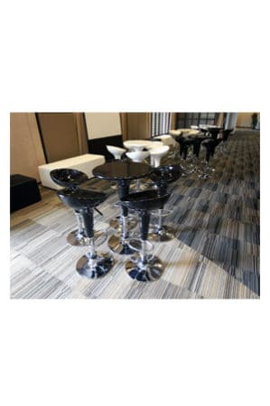 a group of black and white replica bombo tables in a lobby