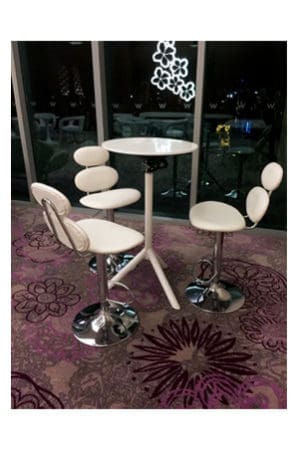 three white stools and a replica miura bar table in a lobby
