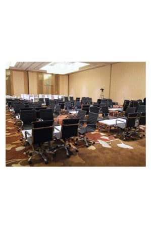 a large conference room with replica eames executive chairs mid back and tables