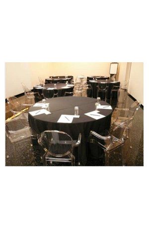 a conference room with replica louis ghost chairs and tables