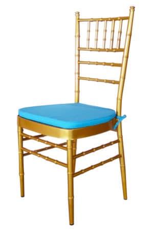 a gold tiffany chair with blue cushion