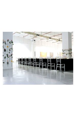 a large room filled with tiffany chairs white and flowers