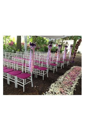 a wedding ceremony set up with tiffany chairs white and flowers