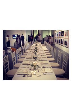a long table and tiffany chair white are set up in a room