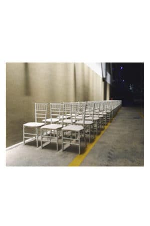 a row of tiffany chairs white lined up in a hallway