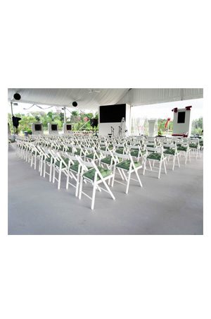 classic white folding chairs set up in a tent