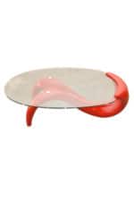 a red glass replica panama coffee table with a curved shape