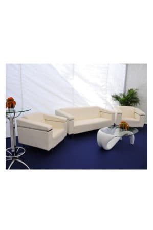 a white sofa set in a tent with a replica panama coffee table
