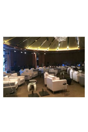 a large room filled with white replica panama coffee tables and chairs