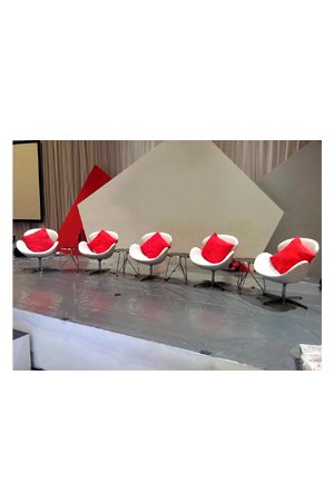 a set of white and red triped side tables on a stage
