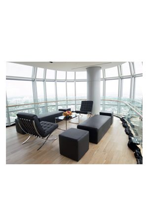 a living room with a black trays coffee table and a view of the city