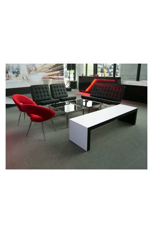 a black and white living room with red and black trays coffee table
