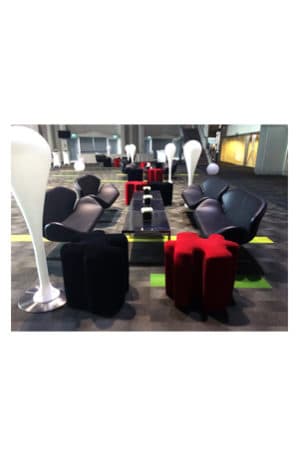 a group of black and red trays coffee tables in a lobby