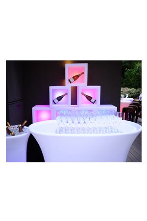 a bar with an illuminated cube box and a bottle of champagne