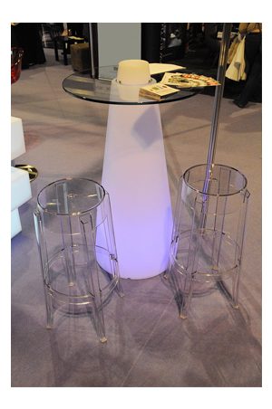 an illuminated pinnacle bistro table with two stools and a light on it