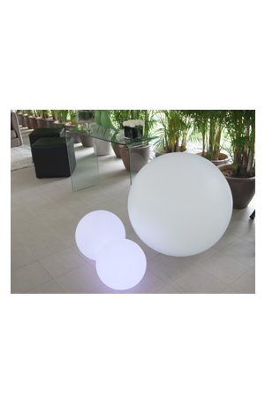 an illuminated ball 85 sitting on a table in a room