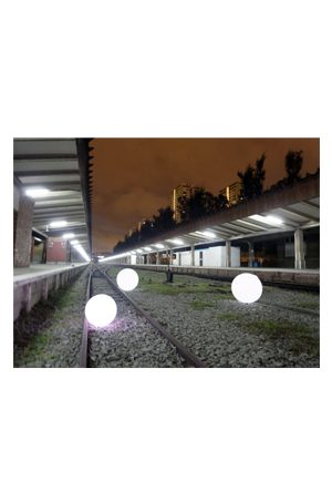 a train station with illuminated ball 85s on the tracks