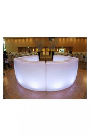 an illuminated circular bar in a large room
