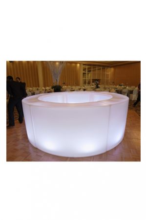 an illuminated circular bar in a large room