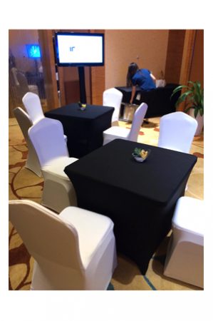 a 3ft square spandex table and chairs in a conference room