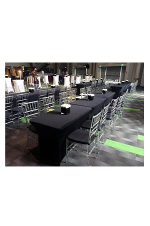a large room with 4ft long spandex tables and chairs set up