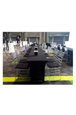 a 4ft long spandex table with black chairs and a black tablecloth
