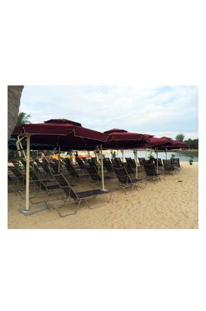 a group of lounge chairs on the beach with parasols