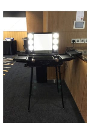 a dressing table with a laptop on it
