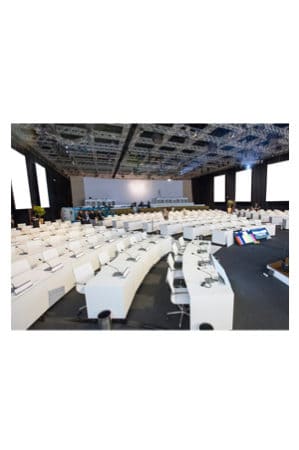 a large conference room with replica eames mesh executive chairs midback and white tables and chairs