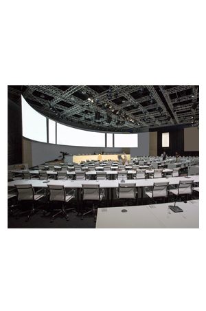 a large conference room with white tables and a replica eames mesh executive chair midback