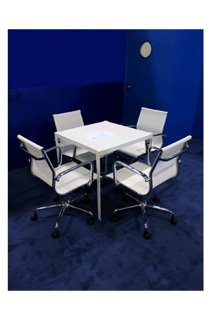 four replica eames mesh executive chairs midback and a white table in a conference room