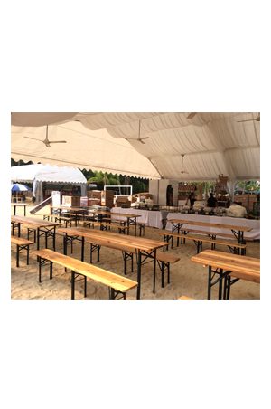 a large tent with classic picnic benches in the middle