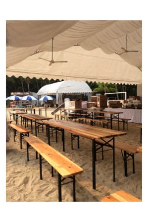 a beach tent with a classic picnic table on the sand